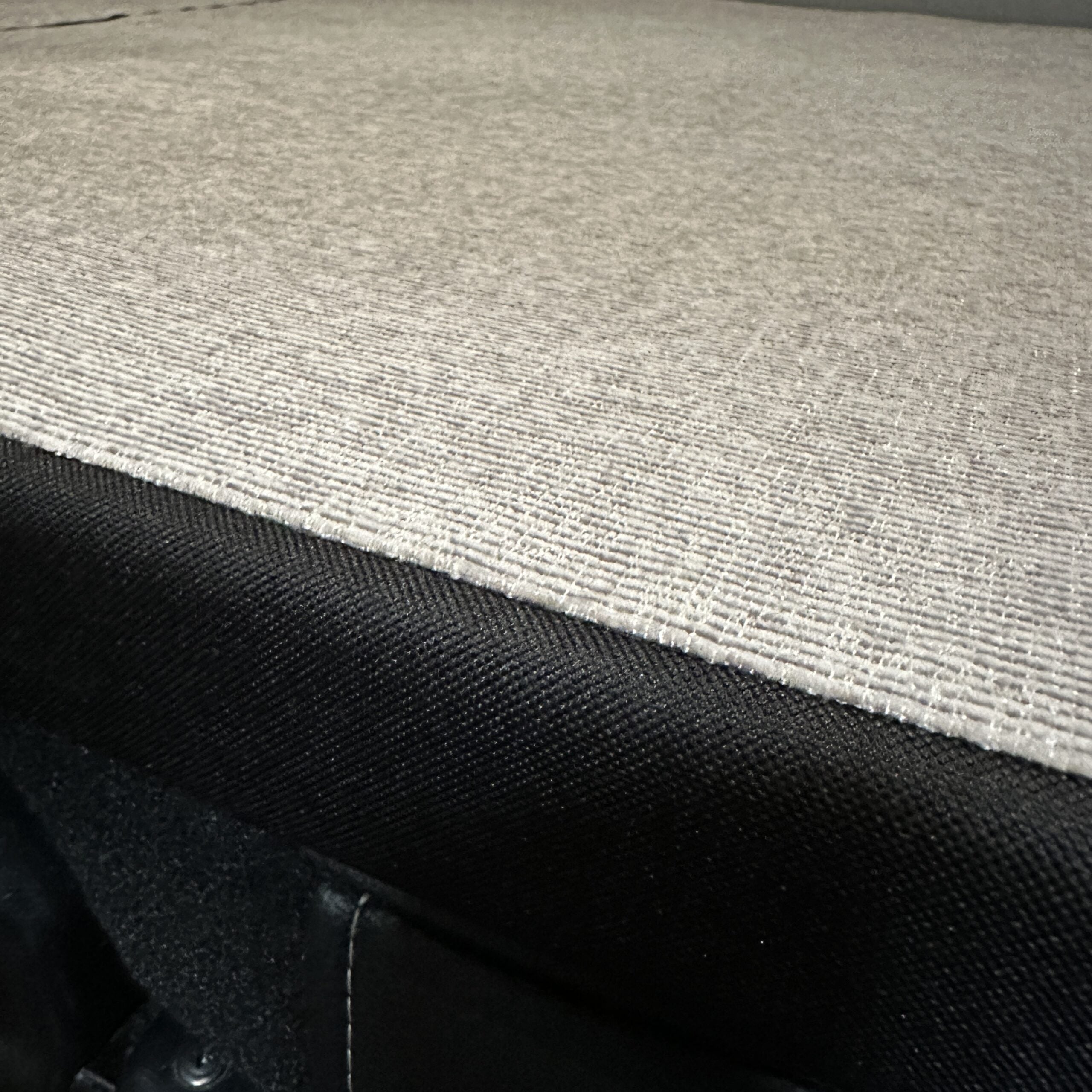 Close-up of Groove Lounge Mattress Topper for the Storyteller van, showing fabric texture and stitching detail.