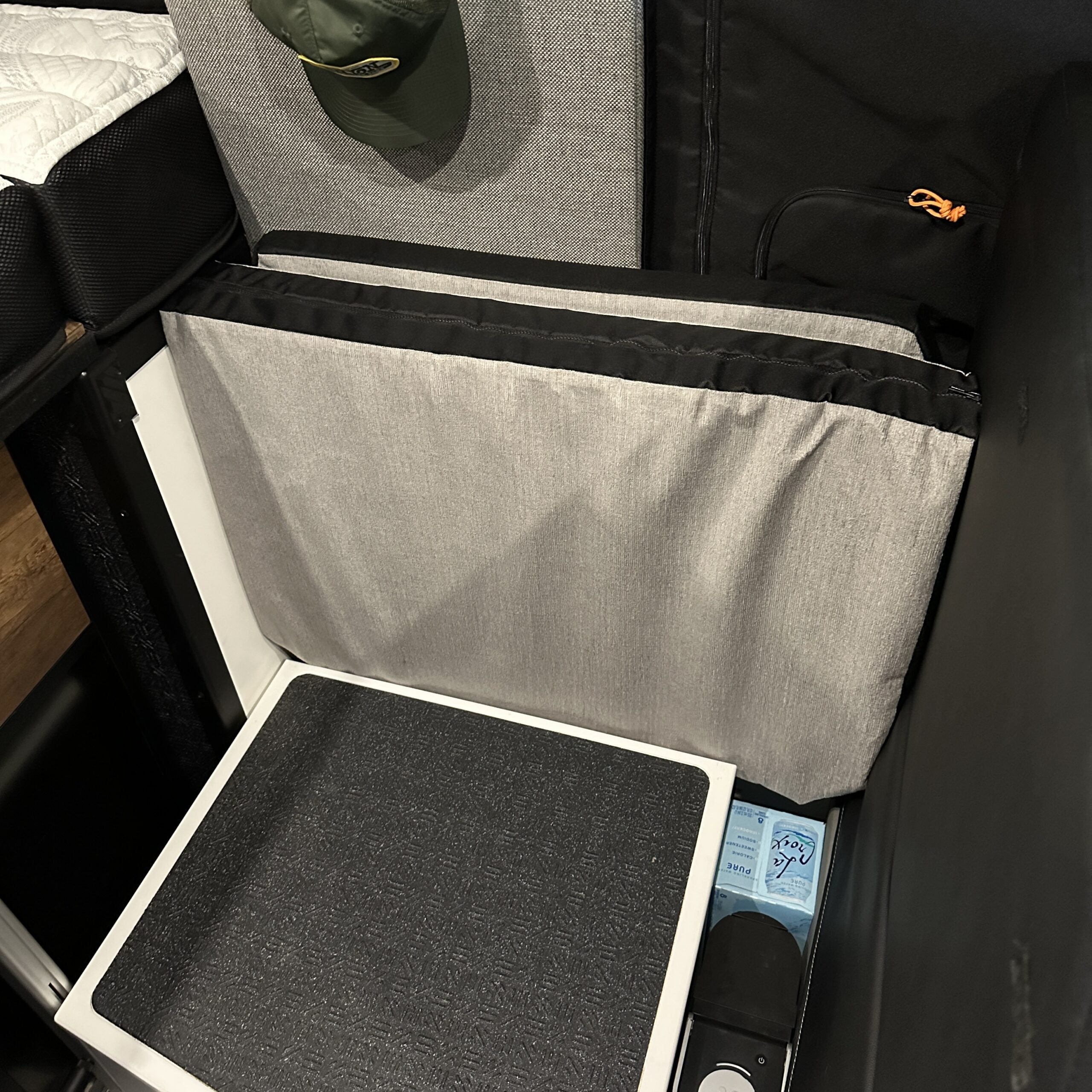 Groove Lounge Mattress Topper for Storyteller van stored vertically behind seat in compact setup
