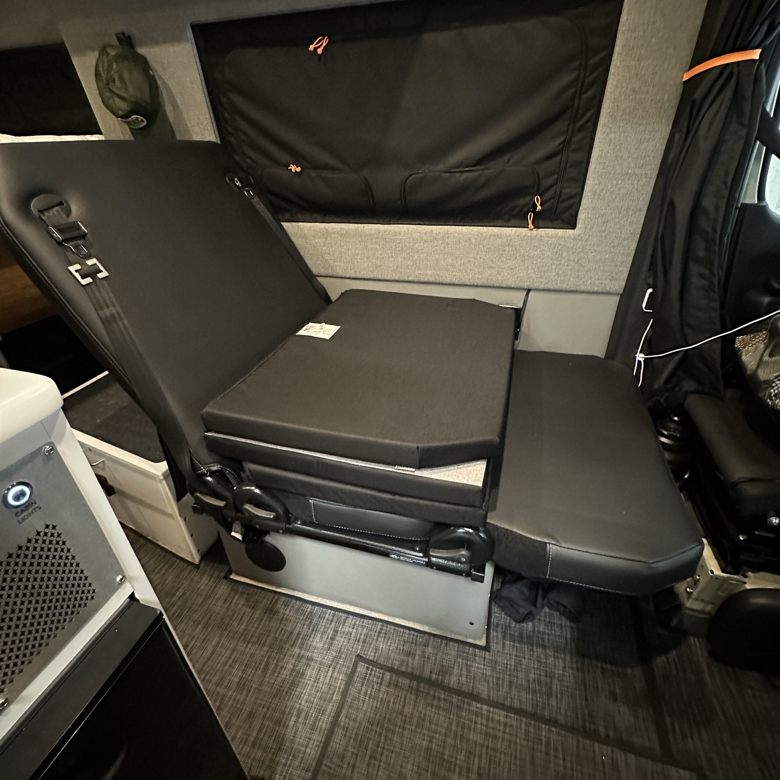 Groove Lounge Mattress Topper by Revel shown on folded bed in van interior