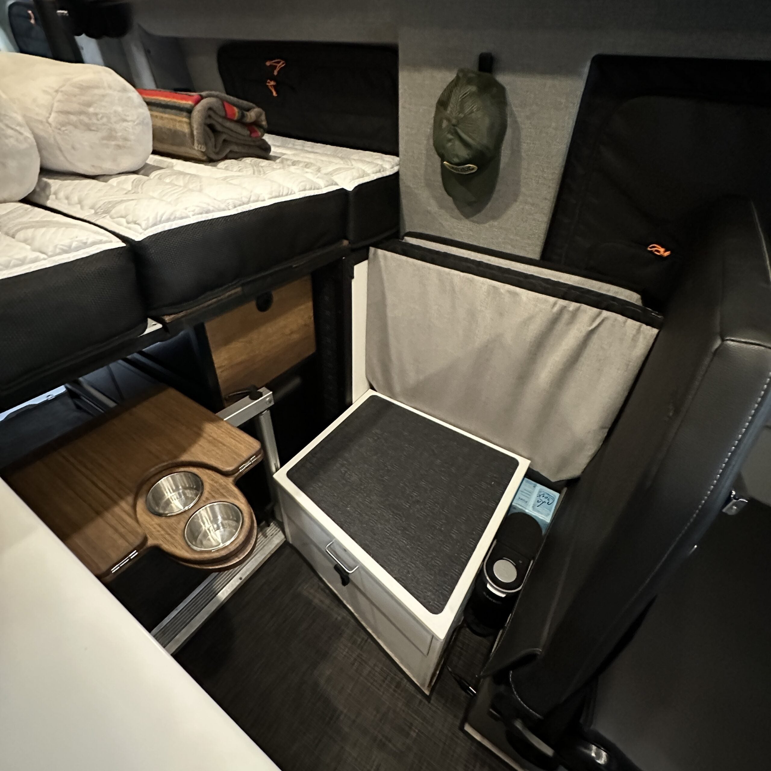 Groove Lounge Mattress Topper by Revel in a Storyteller van lounge setup with storage and cupholders visible