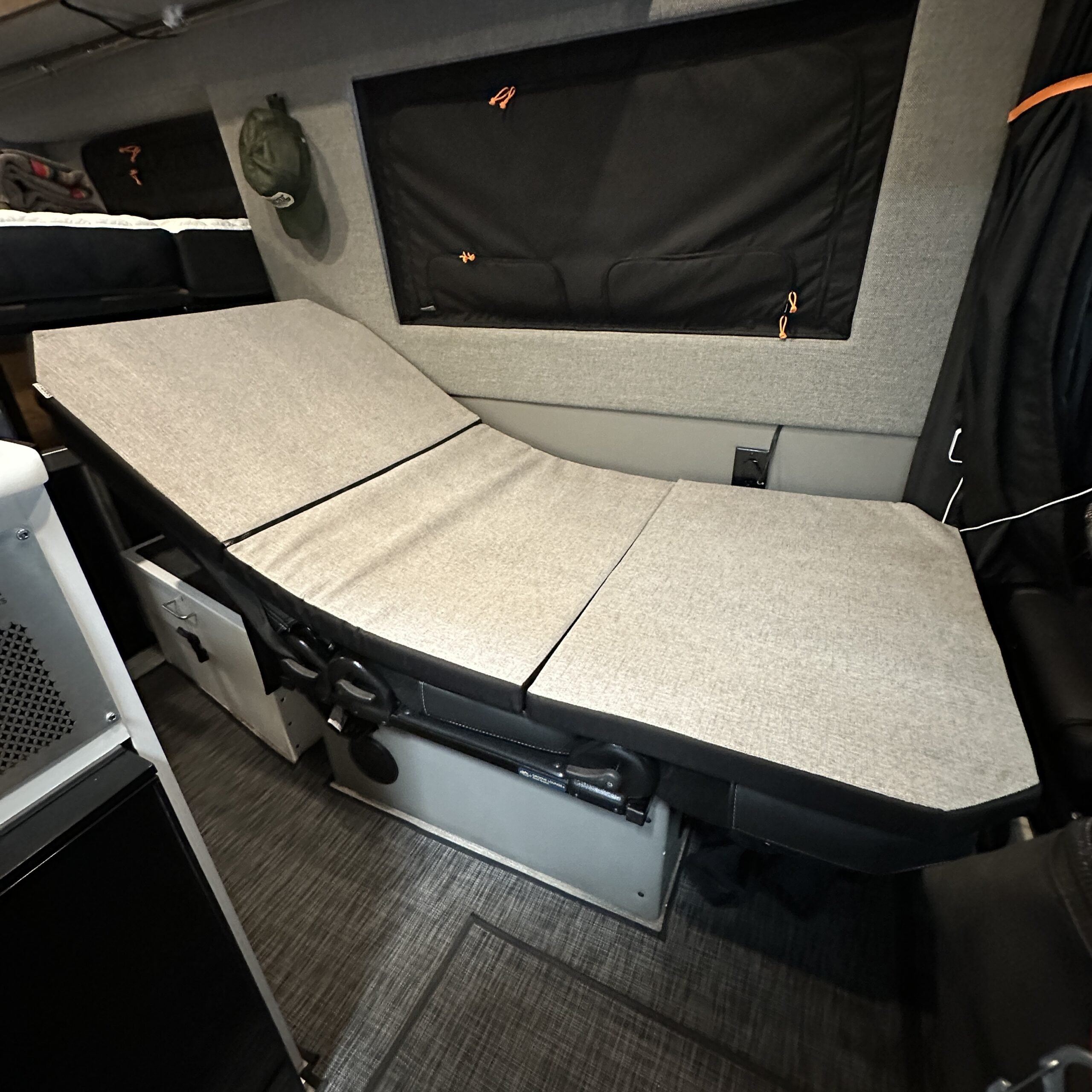 Groove Lounge Mattress Topper by Revel shown set up in a reclined position inside a Storyteller van.