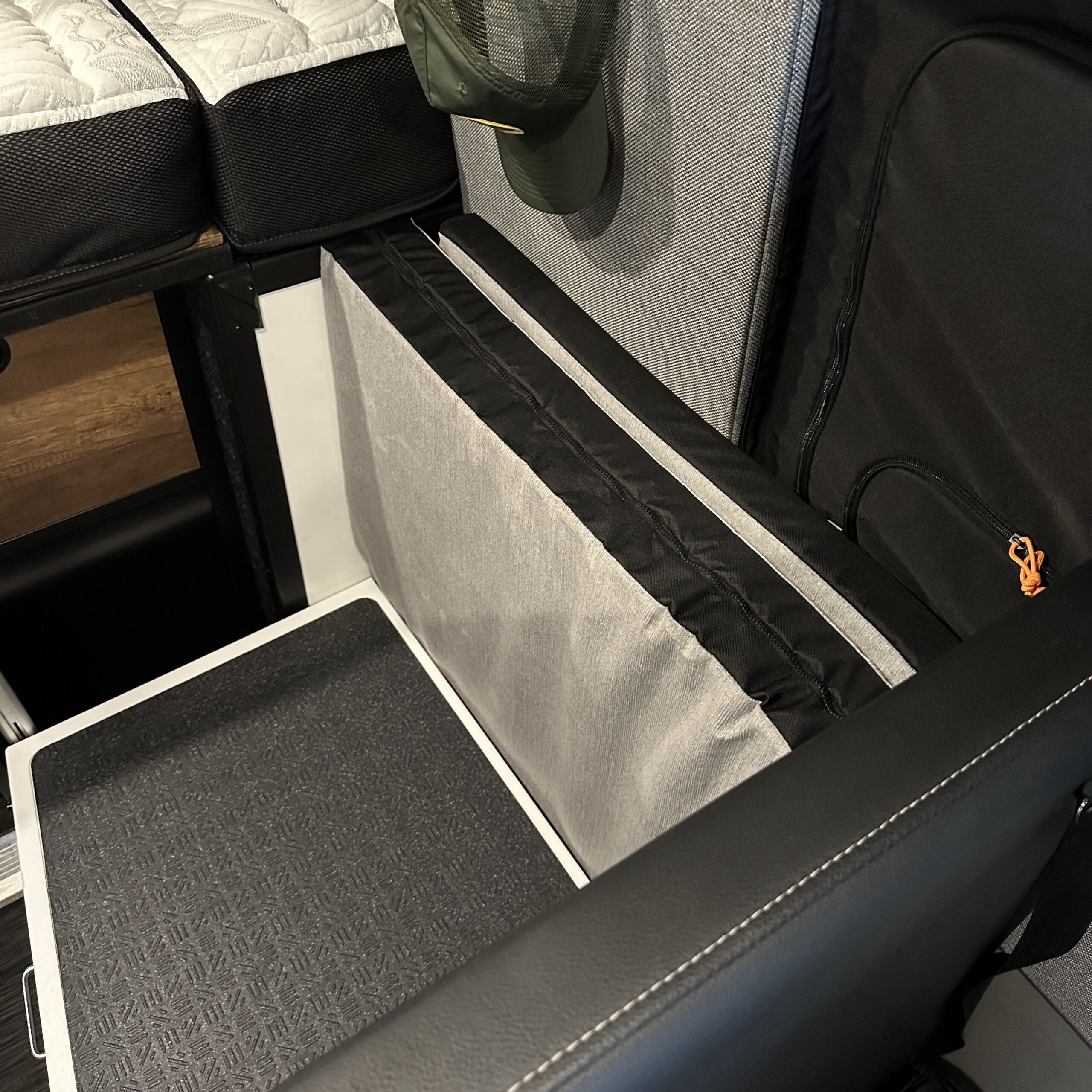 Groove Lounge Mattress Topper by Revel shown folded on rear seat in van interior
