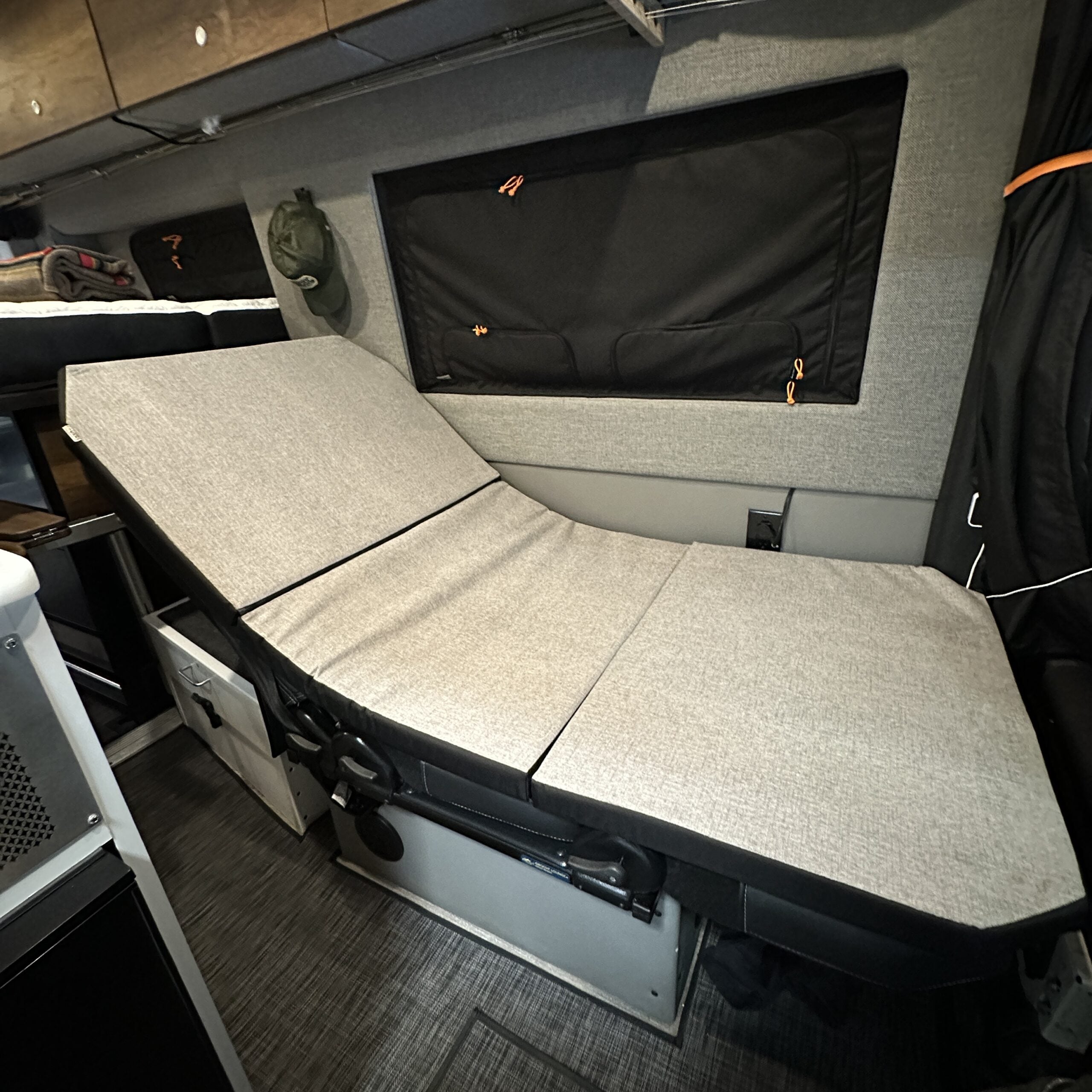 Groove Lounge Mattress Topper for the Storyteller van with adjustable reclining bed setup.