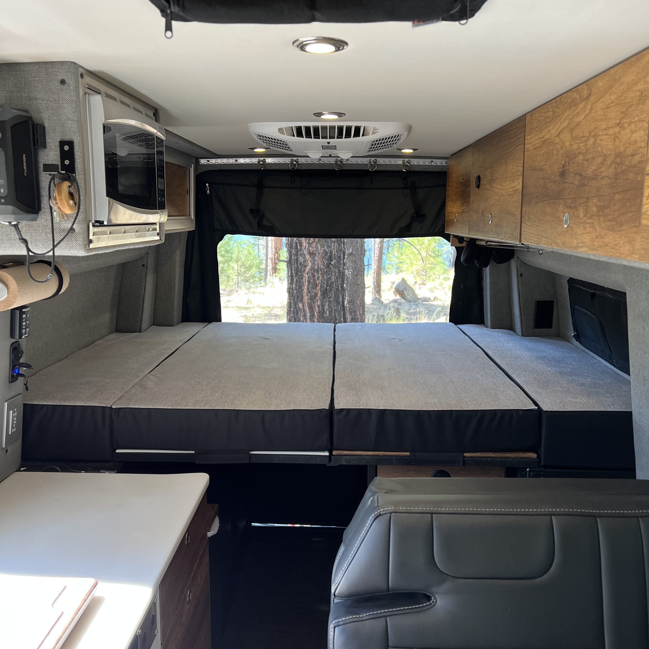 Luxe5 Cooling Memory Foam 5-inch mattress set up as a full bed in a Storyteller MODE van interior.