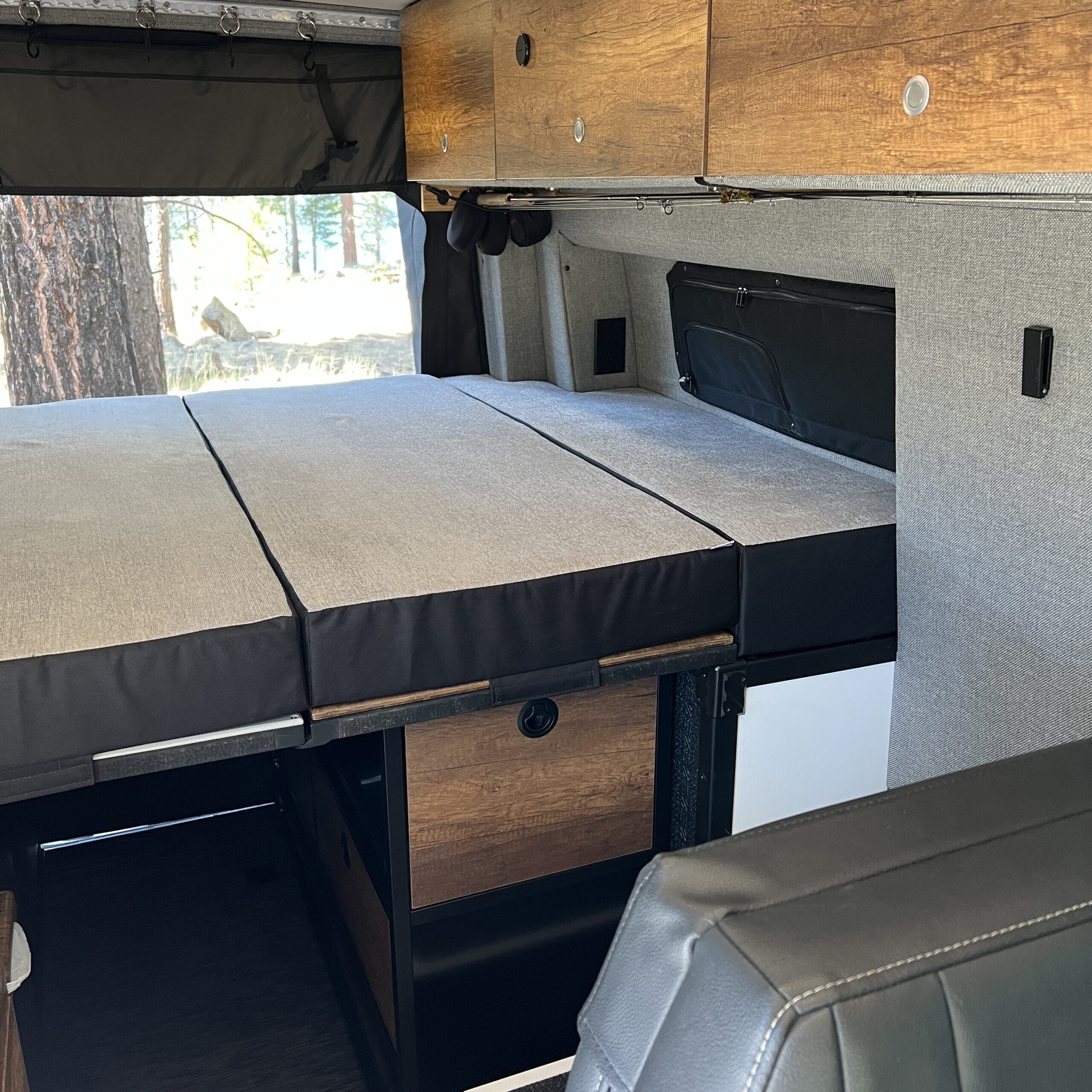Luxe5 Cooling Memory Foam mattress laid out in semi firm bed setup inside a Storyteller MODE van.