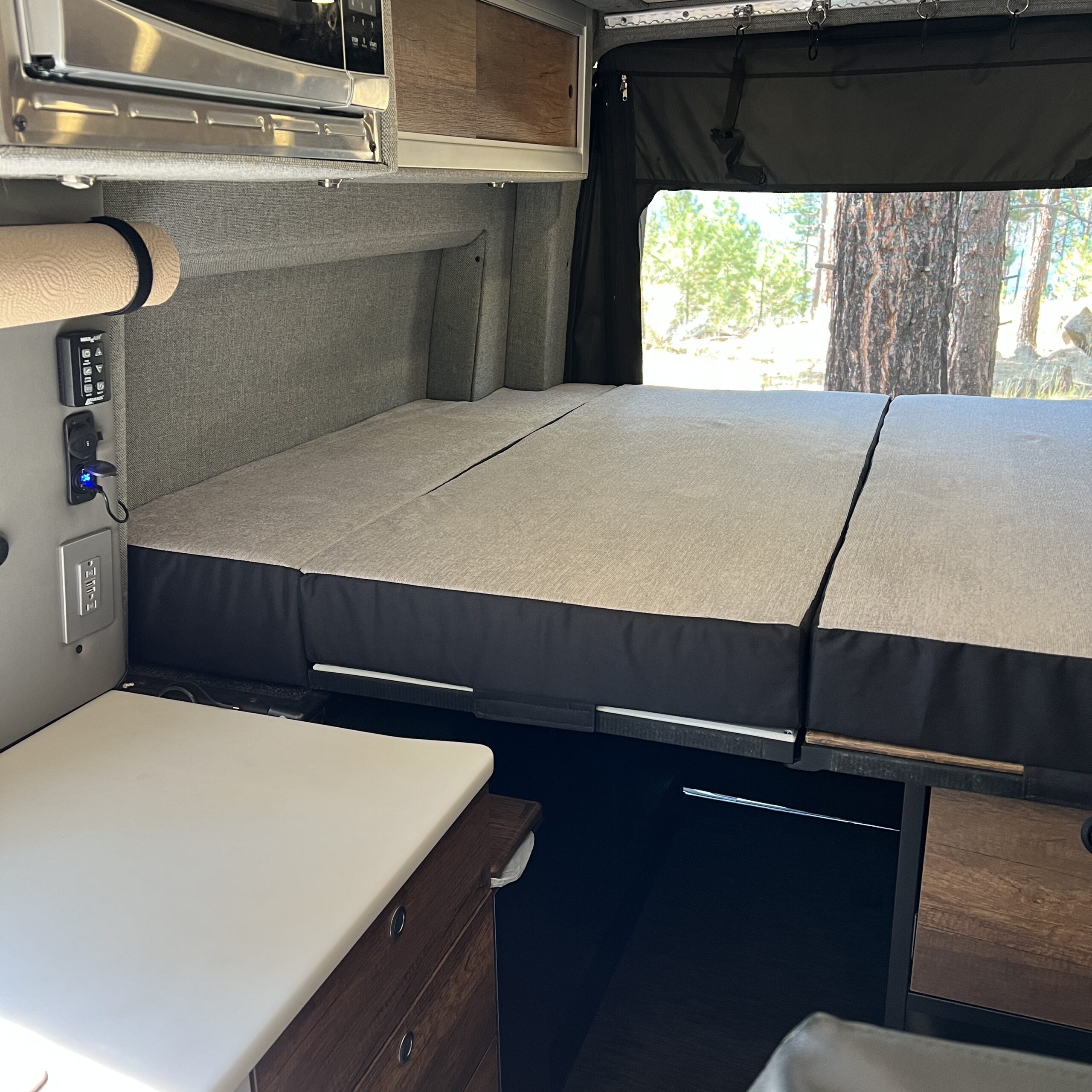 Luxe5 Cooling Memory Foam 5-inch mattress set up in a Storyteller MODE van interior.