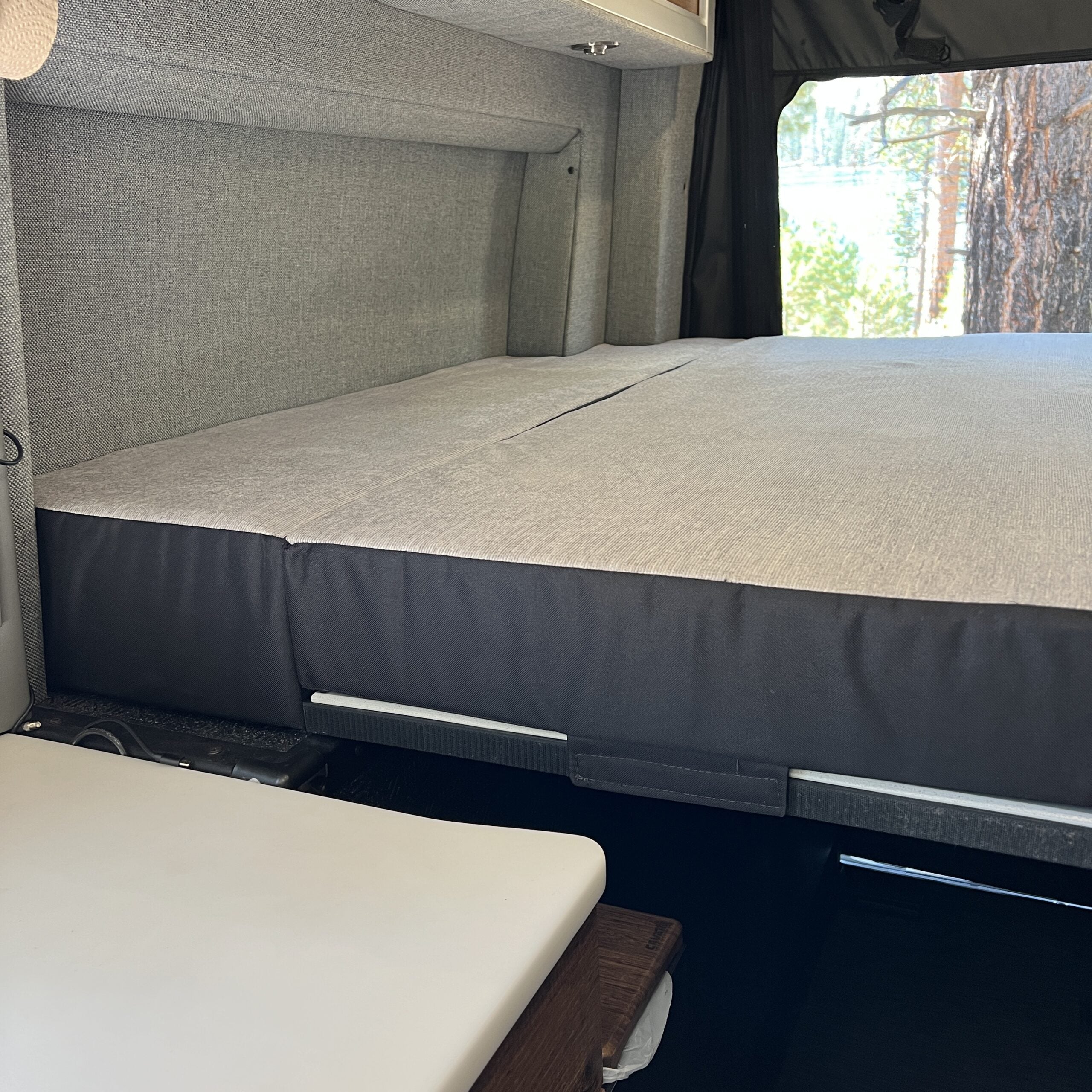 Luxe5 Cooling Memory Foam 5-inch mattress in a van interior with gray fabric walls