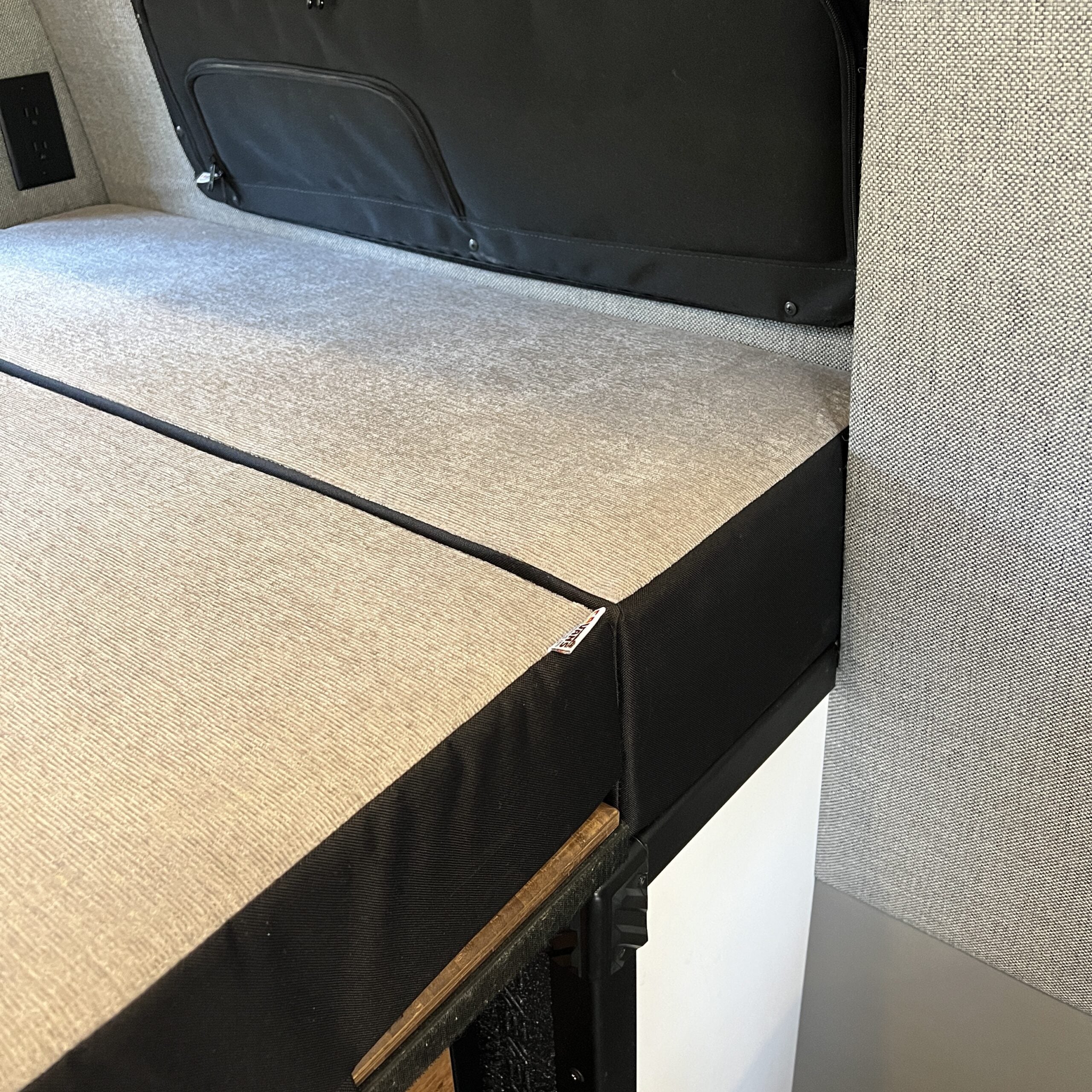 Luxe5 semi firm memory foam mattress laid out in a van interior with textured beige cover.