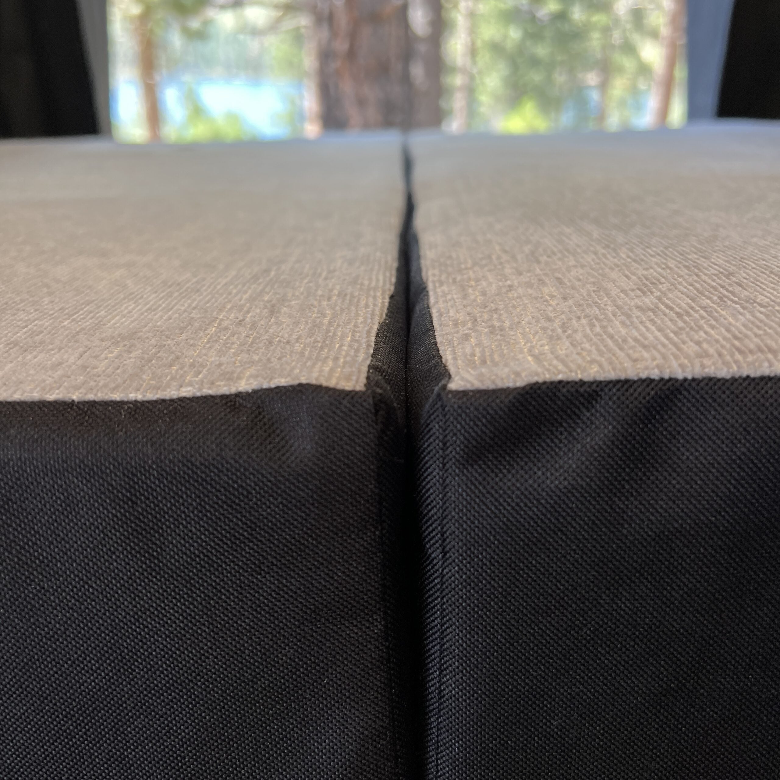 Close-up of Luxe5 Cooling Memory Foam 5-inch mattress in a van with tree view through rear windows.