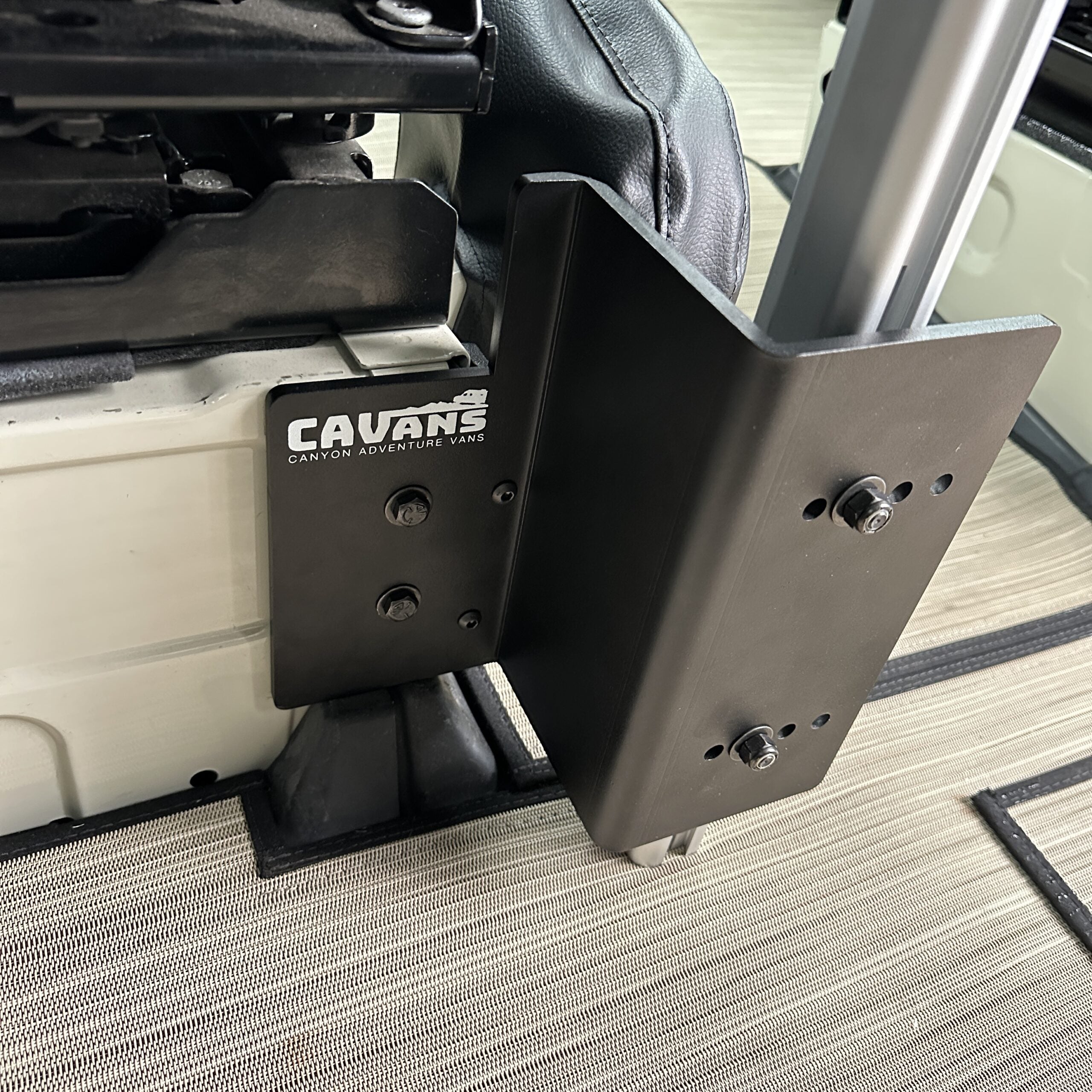 CAVANS bracket installed between van seat and console table leg mount