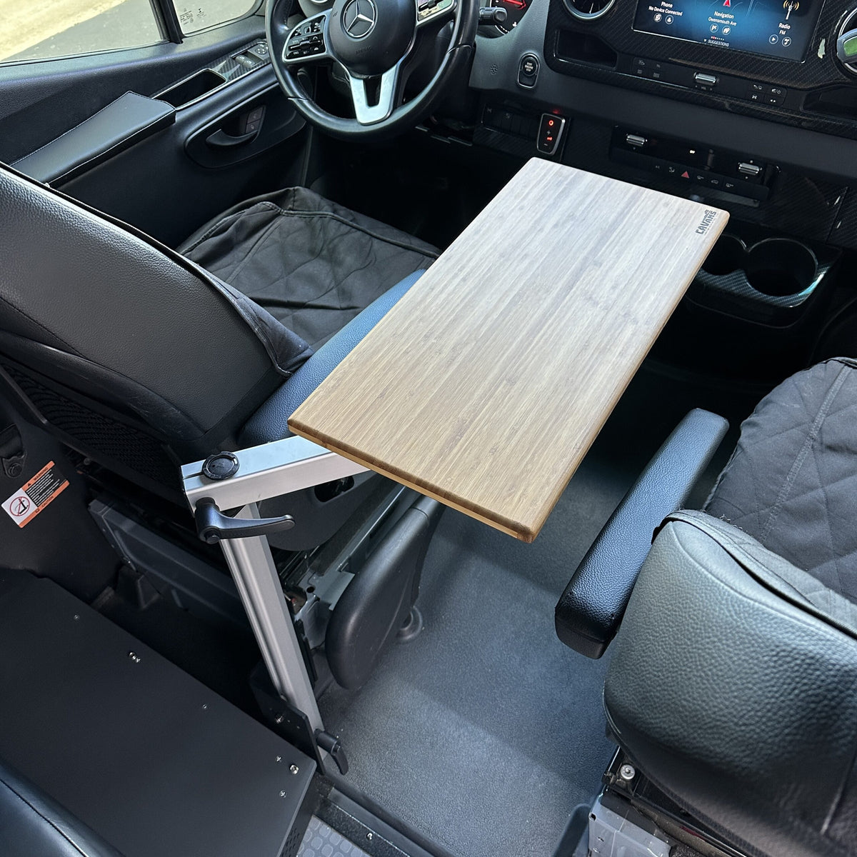 table mount Long Leg table mounted between van driver and passenger seats with wood top extended.