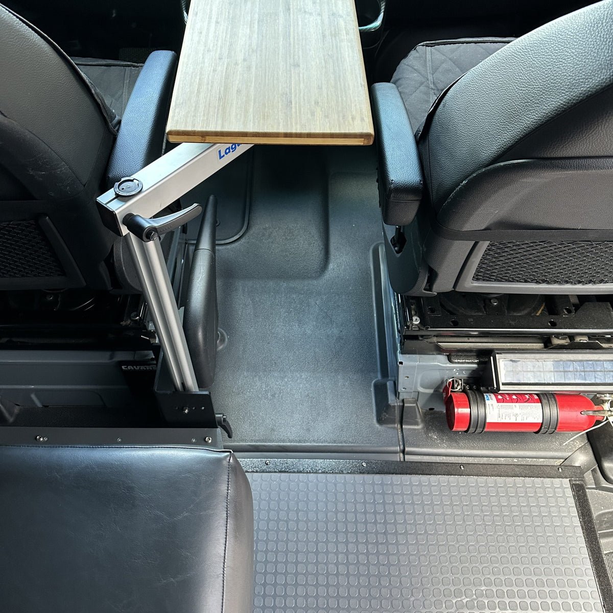 table mount Long Leg table mount installed between front seats in a van interior.