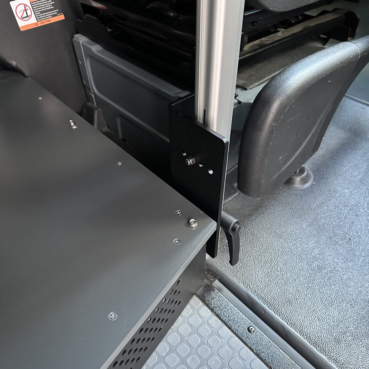 Console table bracket mounted beside seat in a van interior