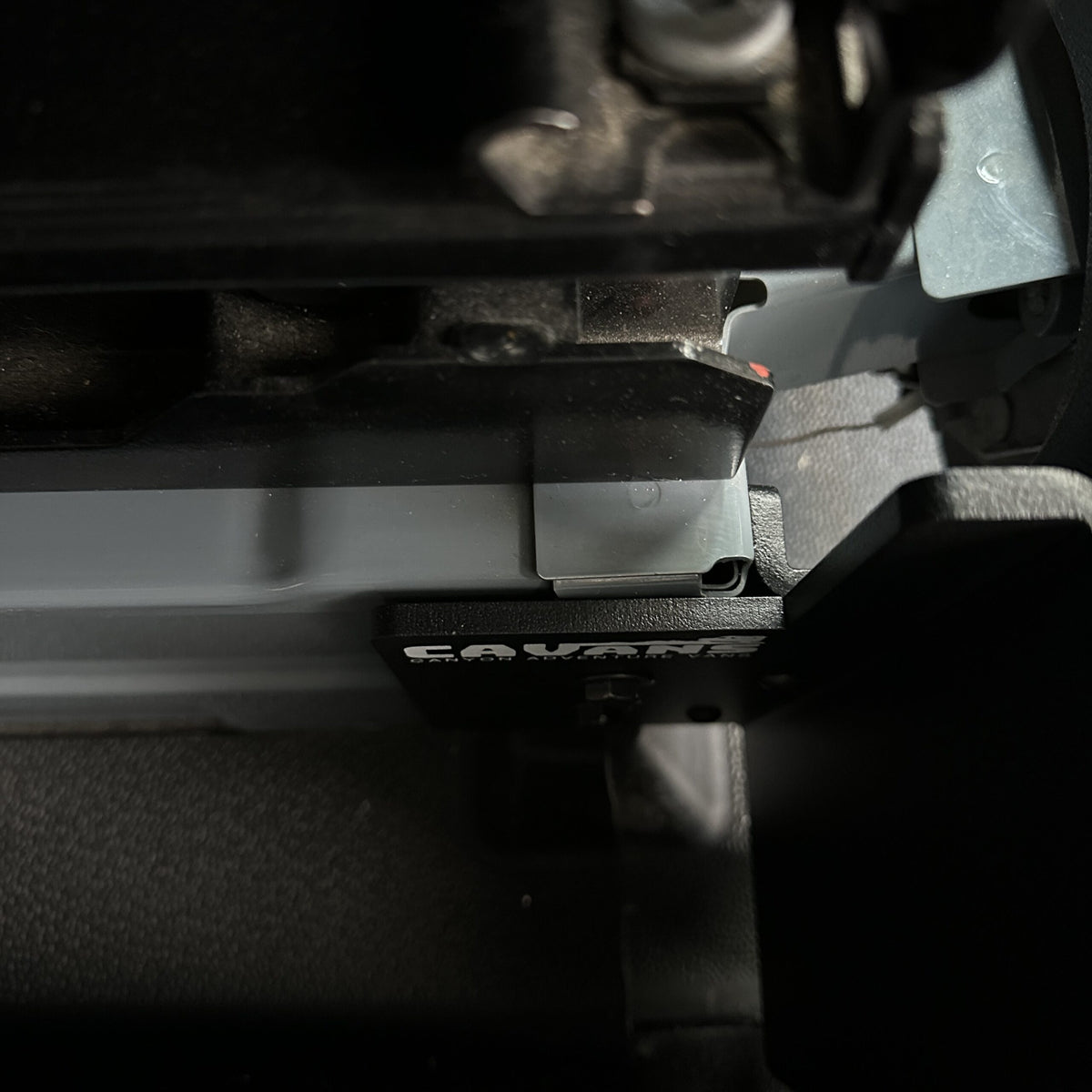 Close-up of table mount Long Leg mounting bracket attached inside van interior.