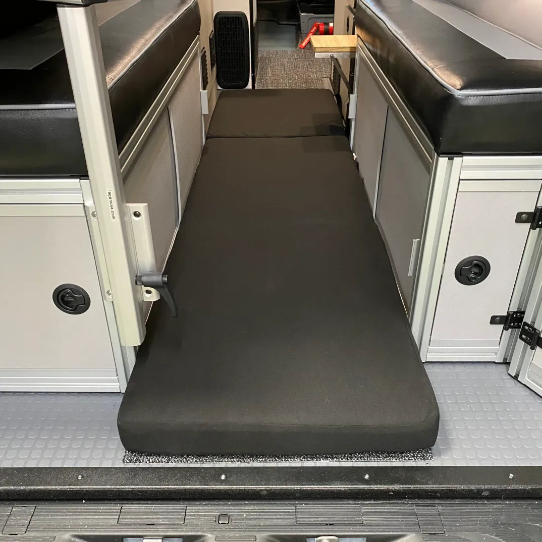 Revel floor mattress laid out between van benches for added sleeping space.