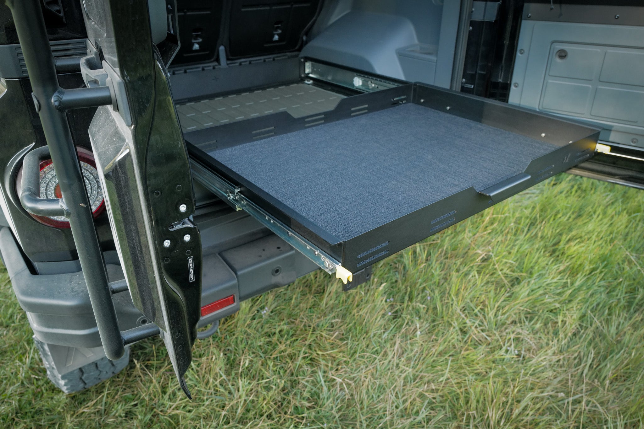INEOS Grenadier Cargo Tray System Pro fully extended to grab gear
