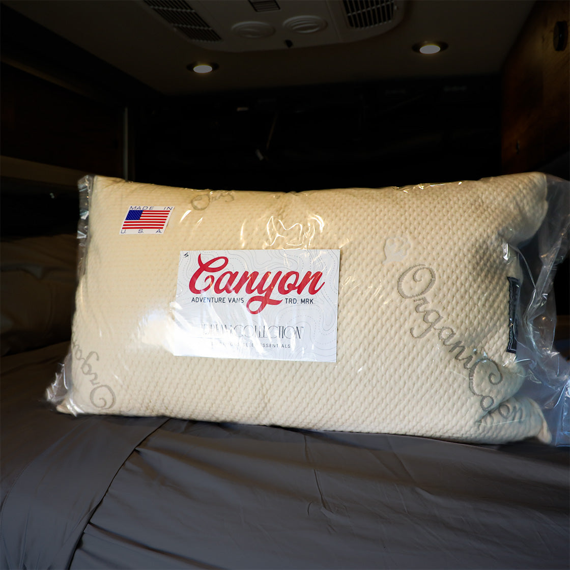 Canyon Dream Collection adjustable pillow in plastic wrap on a bed inside a van