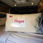 Canyon Dream Collection adjustable pillow in packaging on a made bed inside a van