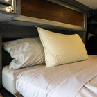 Dream Collection adjustable pillow on a neatly made bed inside a van sleeping area