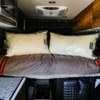 Dream Collection adjustable pillows by Storyteller placed on a bed in the back of a van.