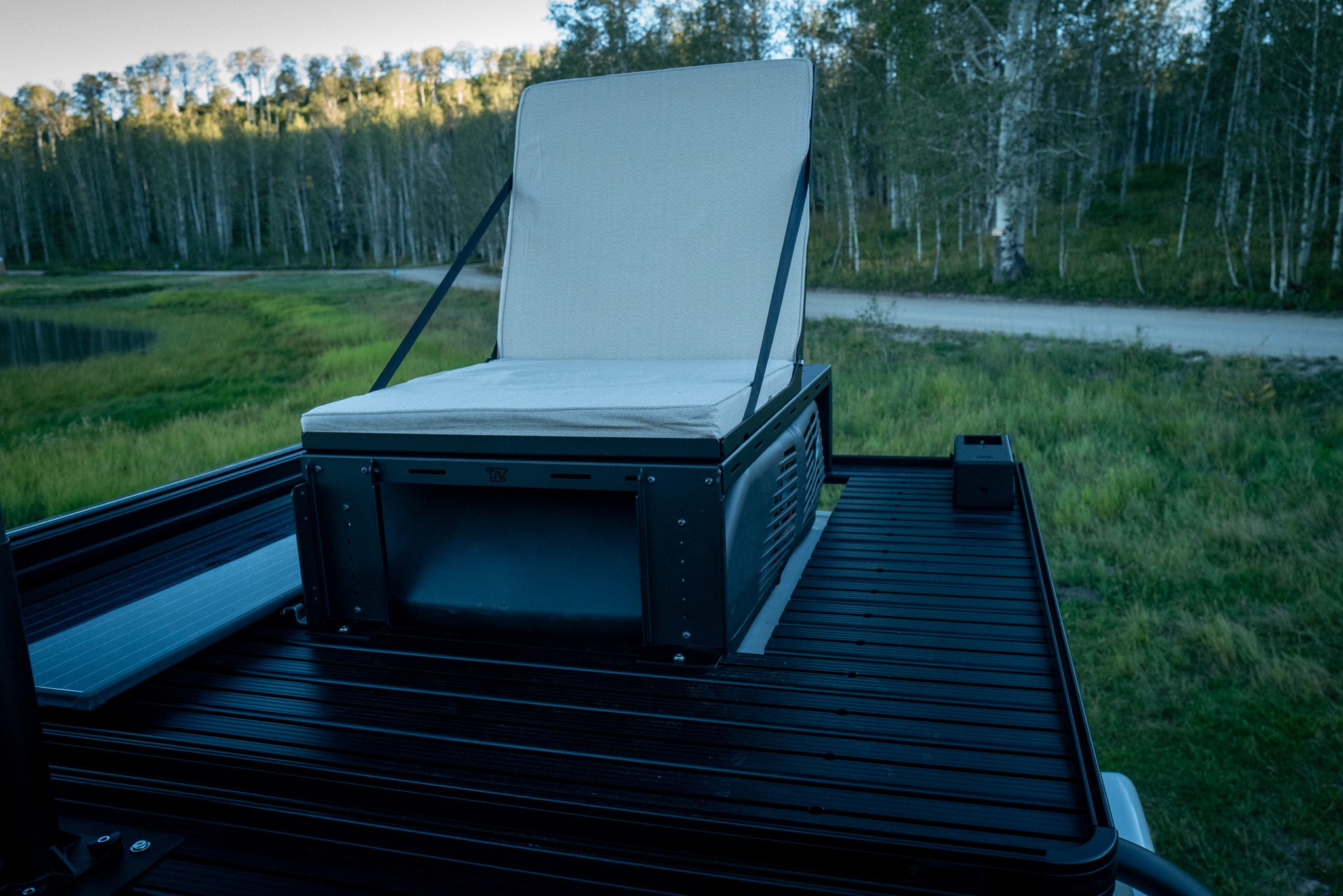 Van rooftop folding seat over the ac unit
