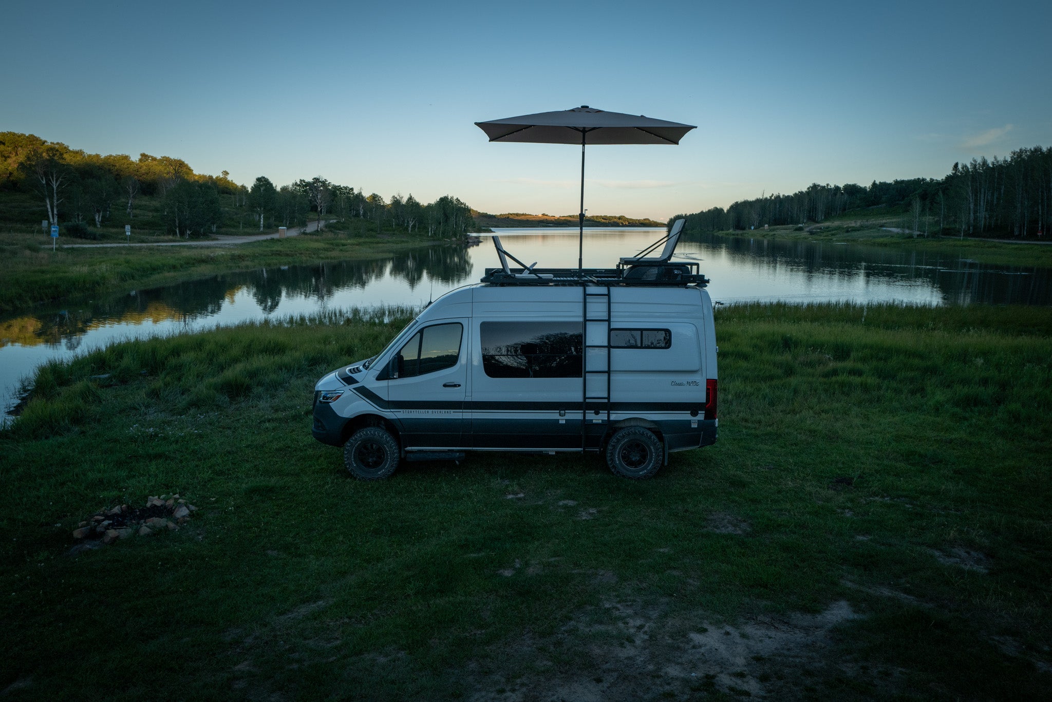 Van rooftop lounge with folding seat and solar light umbrella