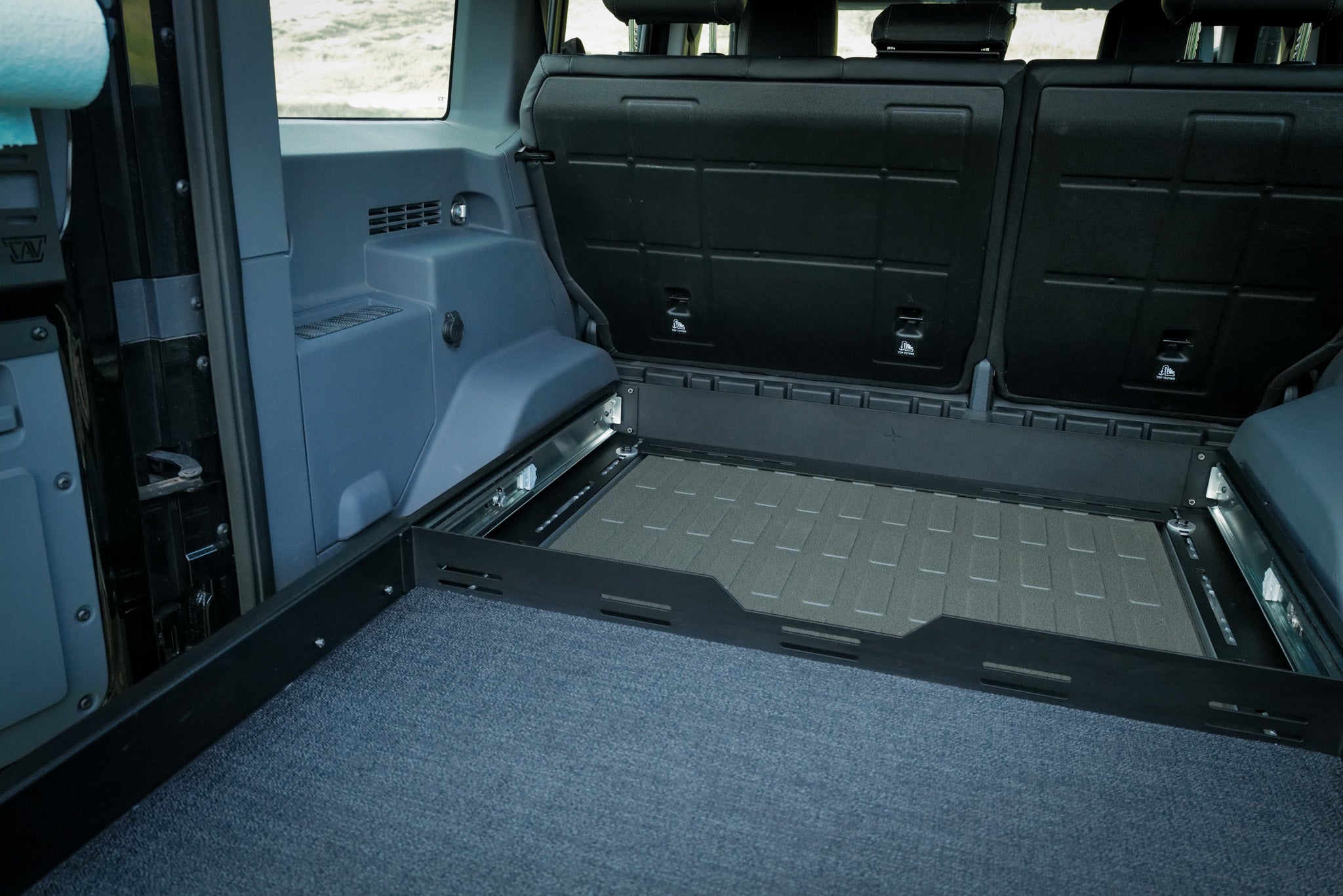 INEOS Grenadier Cargo Tray System bolted to the L-Track