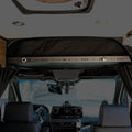 Overhead shelf gear trim installed above driver area in van interior, featuring TAV mounting rail.