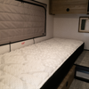 Ultra Luxe mattress inside Winnebago Ekko van with quilted surface and built-in storage underneath.