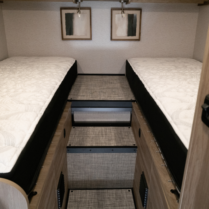 Twin ULTRA Luxe mattresses in Winnebago Ekko van with center step and modern decor.