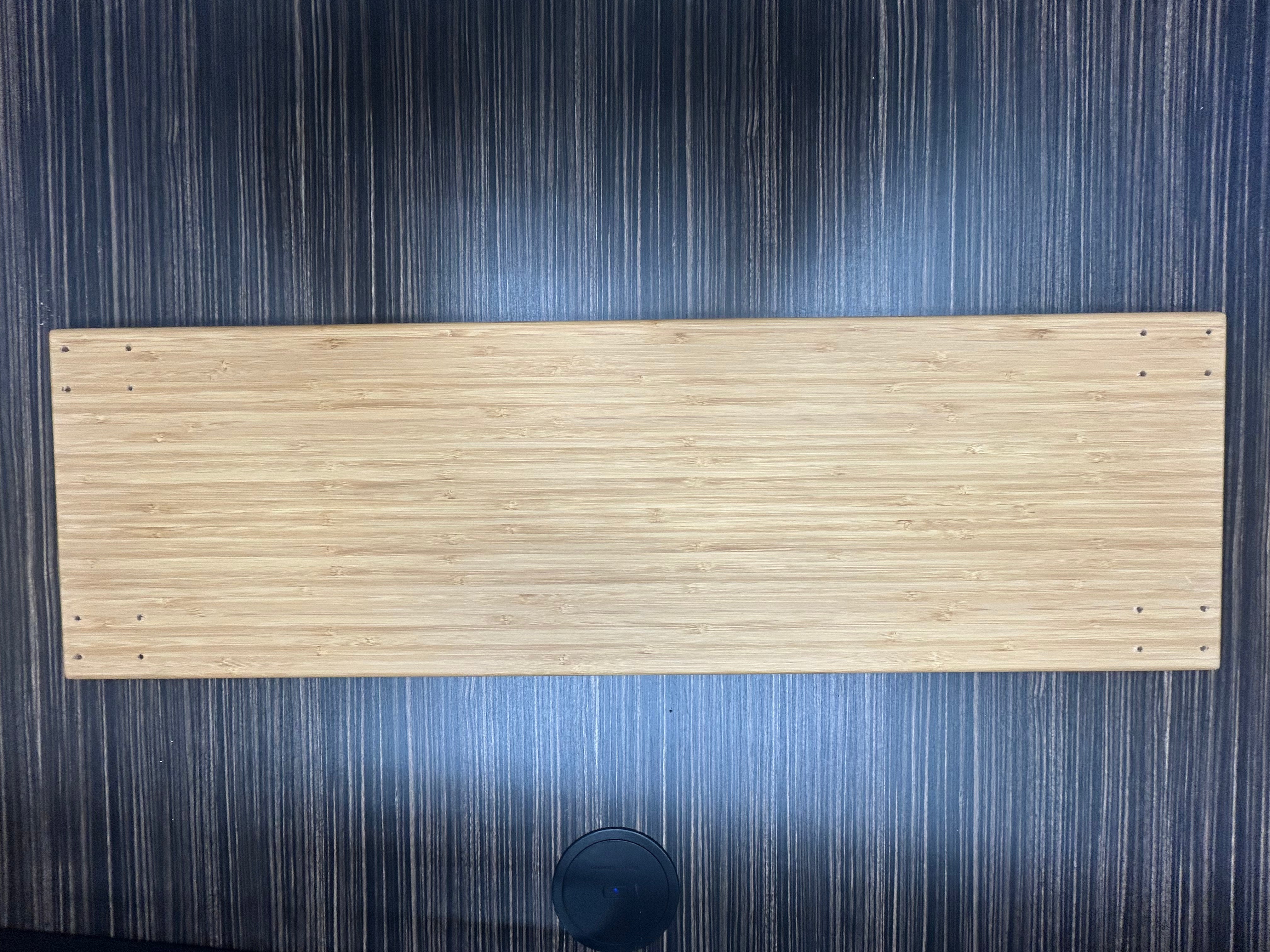 Top view of the Revel adjustable large bamboo shelf on a dark wood surface.