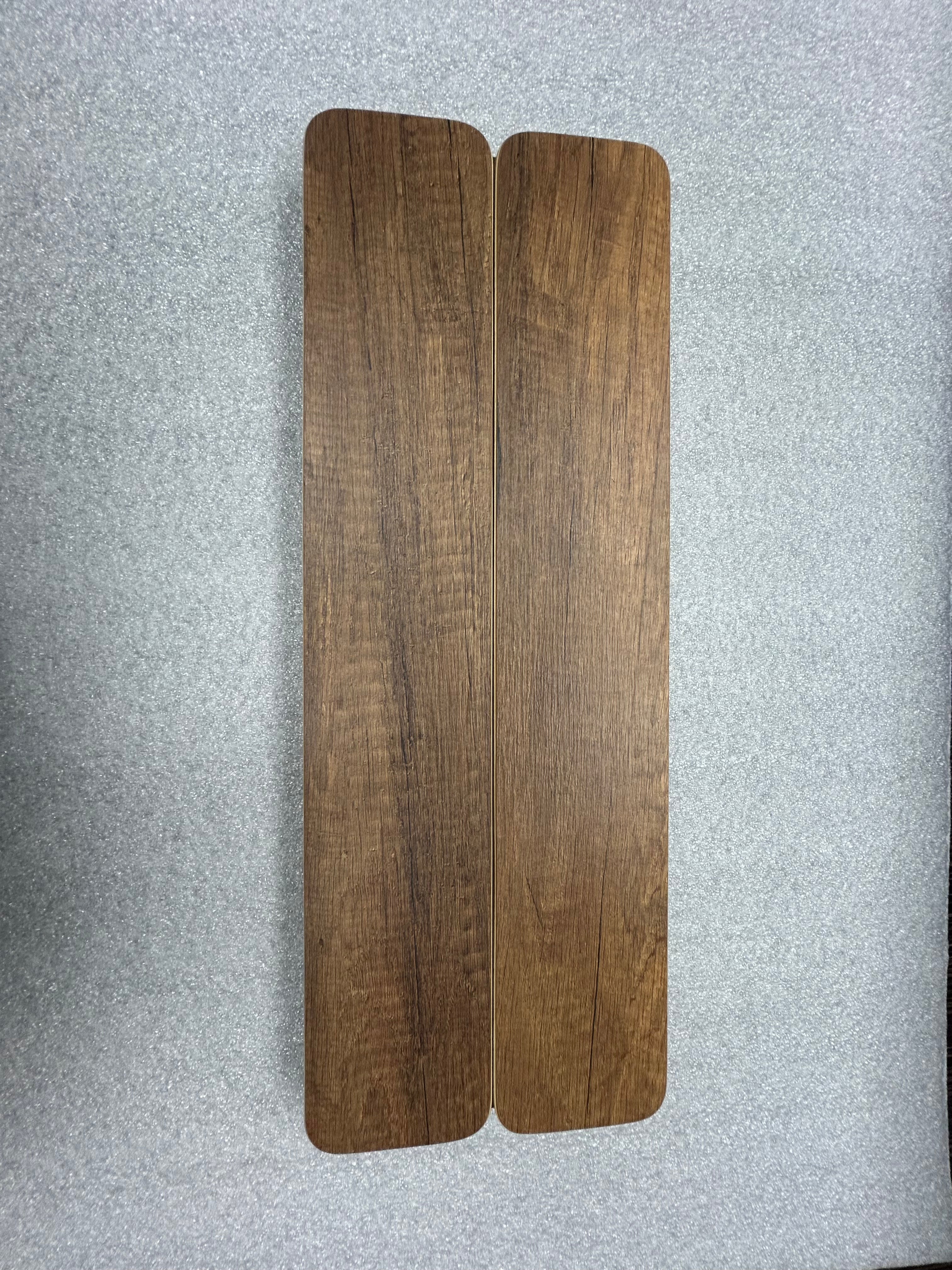 Mini Skinny Folding Table Top in a dark wood finish, shown folded on a gray surface.