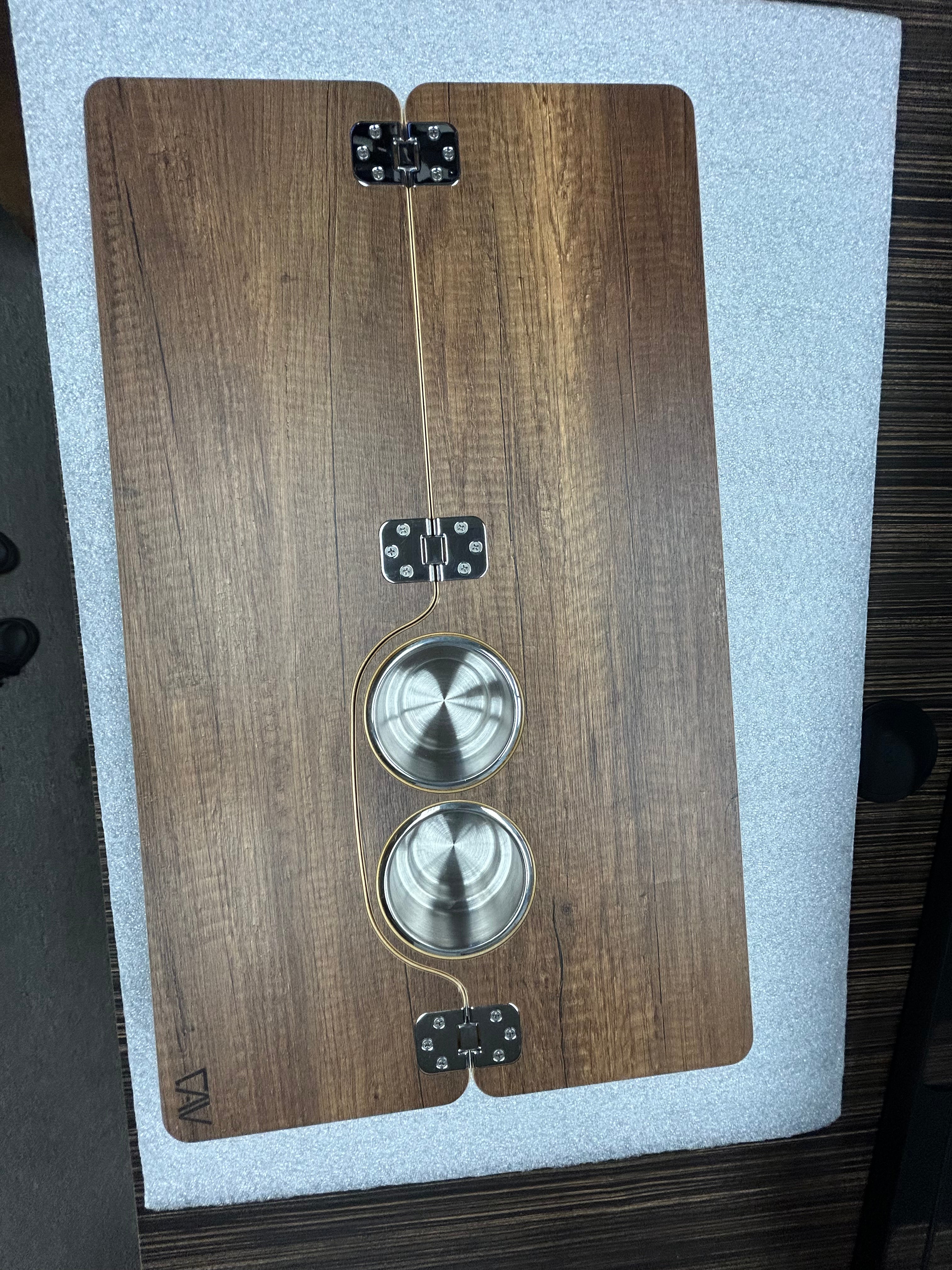 Revel Skinny 2.0 folding table top with wood finish and built-in metal cup holders in van interior.