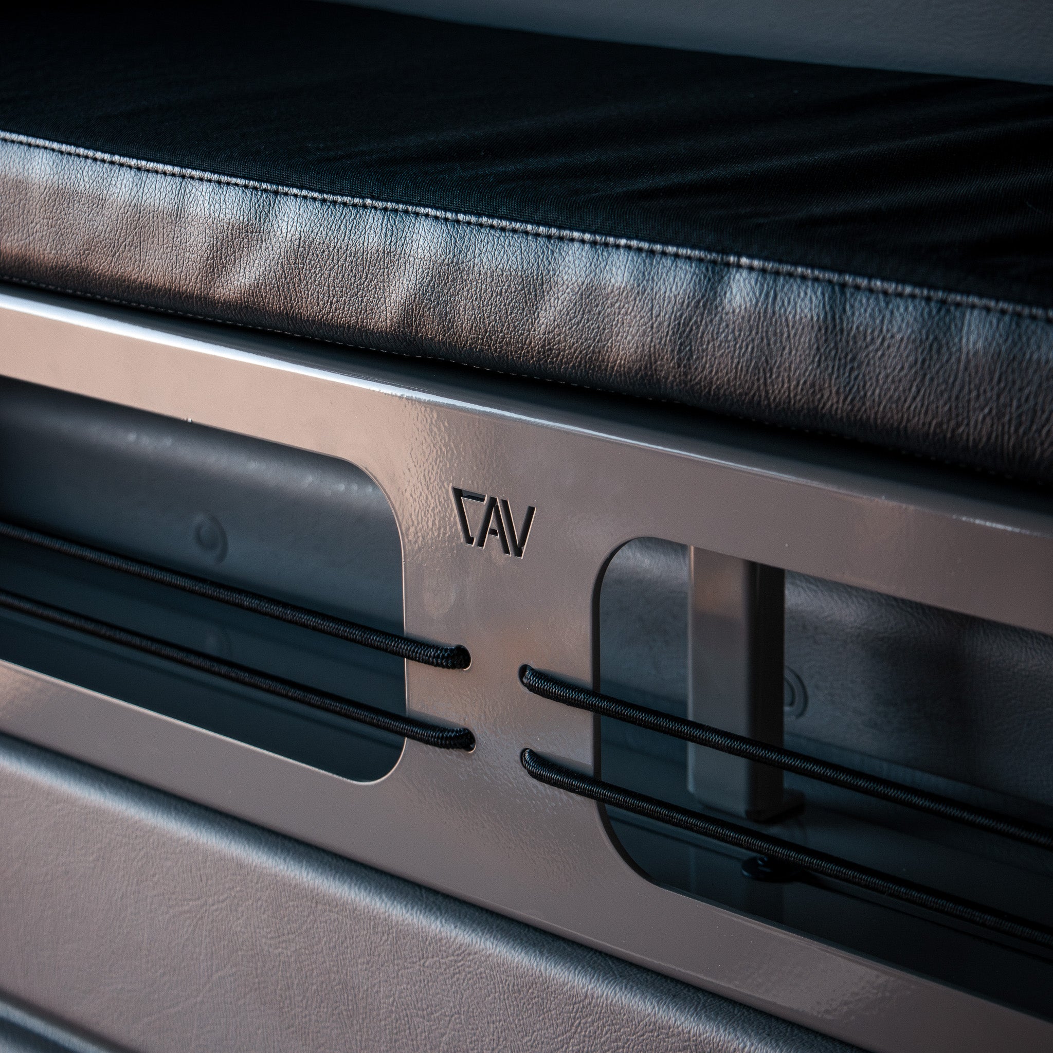 CAV 2-inch Bed Riser Pro Bed Bolsters shown in a van with black cushion and sleek metal frame