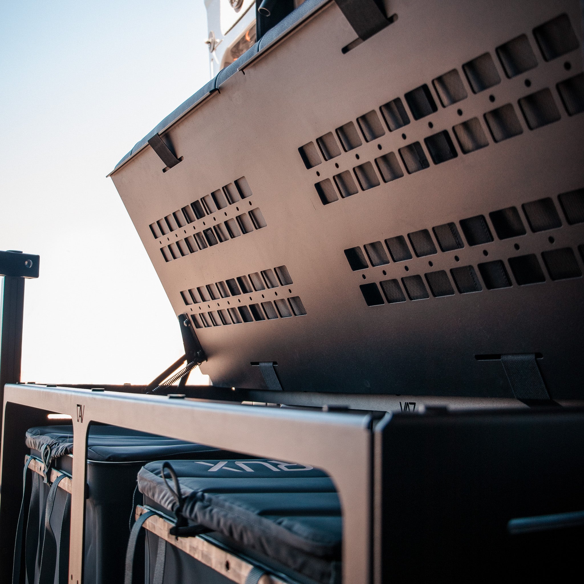 GLSS Rux storage system with open vented cover and visible soft storage bins in a van setup