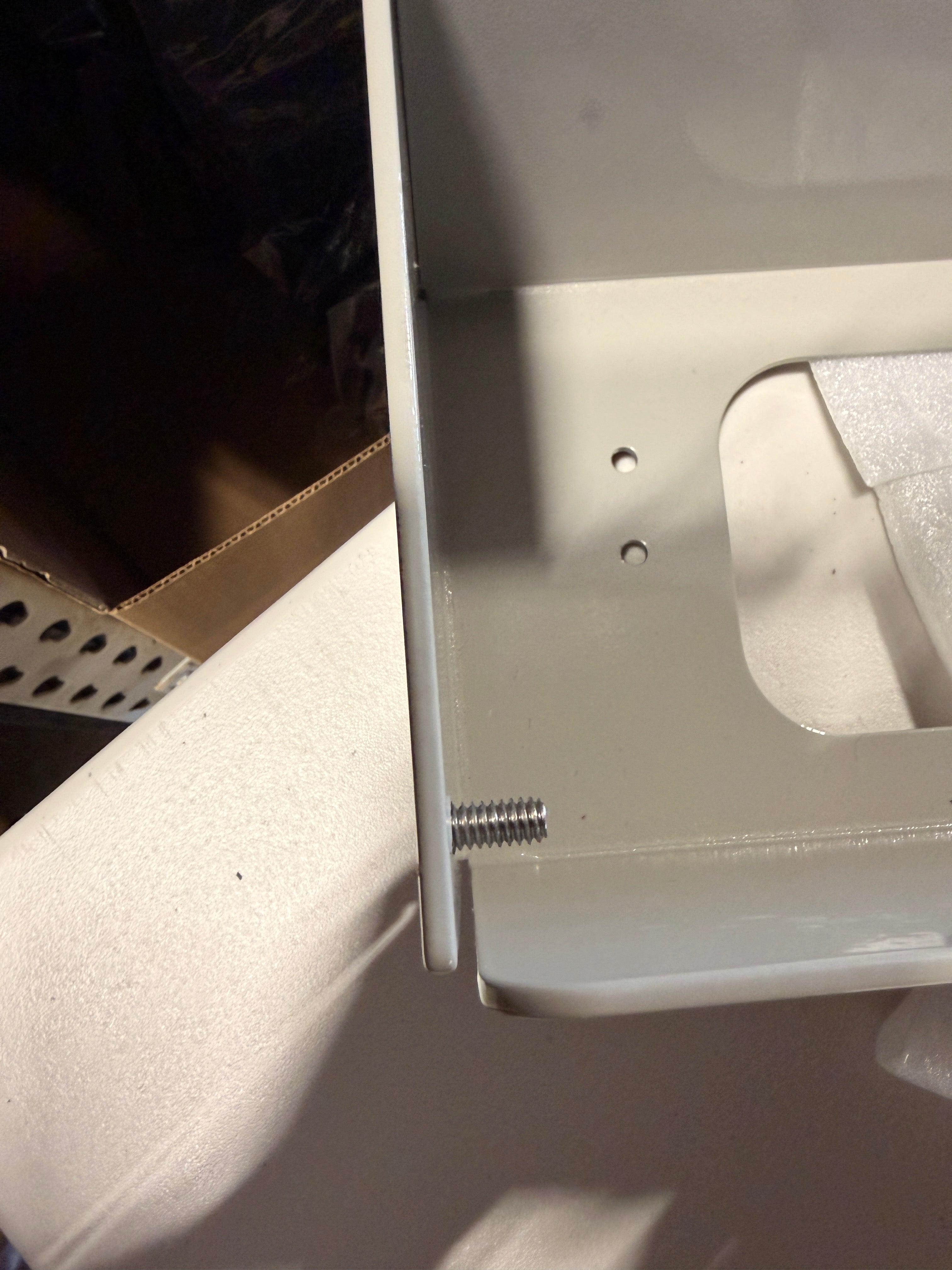 Close-up of the raw metal screw blemish on the grey Last Chance bed riser.