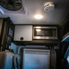 Revel overhead cabinet kit with built-in GE microwave inside van interior ceiling setup.