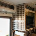 Ekko MOLLE panel mounted on the right side of a van interior beside a microwave unit.