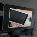 Mounted Storyteller L-Track PRO mirror inside van reflecting soft interior features.