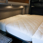 Ultra Luxe mattress protector pad on a fully extended bed inside a van interior