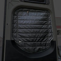 CLIMA-SHADE insulated rear window cover installed on van door interior.