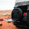 Canyon Tire Carrier Drop Table mounted on the rear of a van in a desert setting
