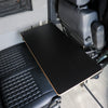 Large Universal Table Top mounted between van seats with black finish and sleek edge detail.