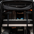 CAV Ultra Luxe mattress setup inside a Revel van with fold-out bed platform and gear storage.