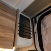 CAV Ekko Cab Cubby mounted inside van near overhead cabinet and insulated door.