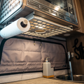 Ekko under cabinet shelf holding paper towel above van sink and soap dispenser