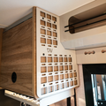 Ekko Molle Panel left side by CAV mounted inside a van with wood cabinetry and white metal grid panel.