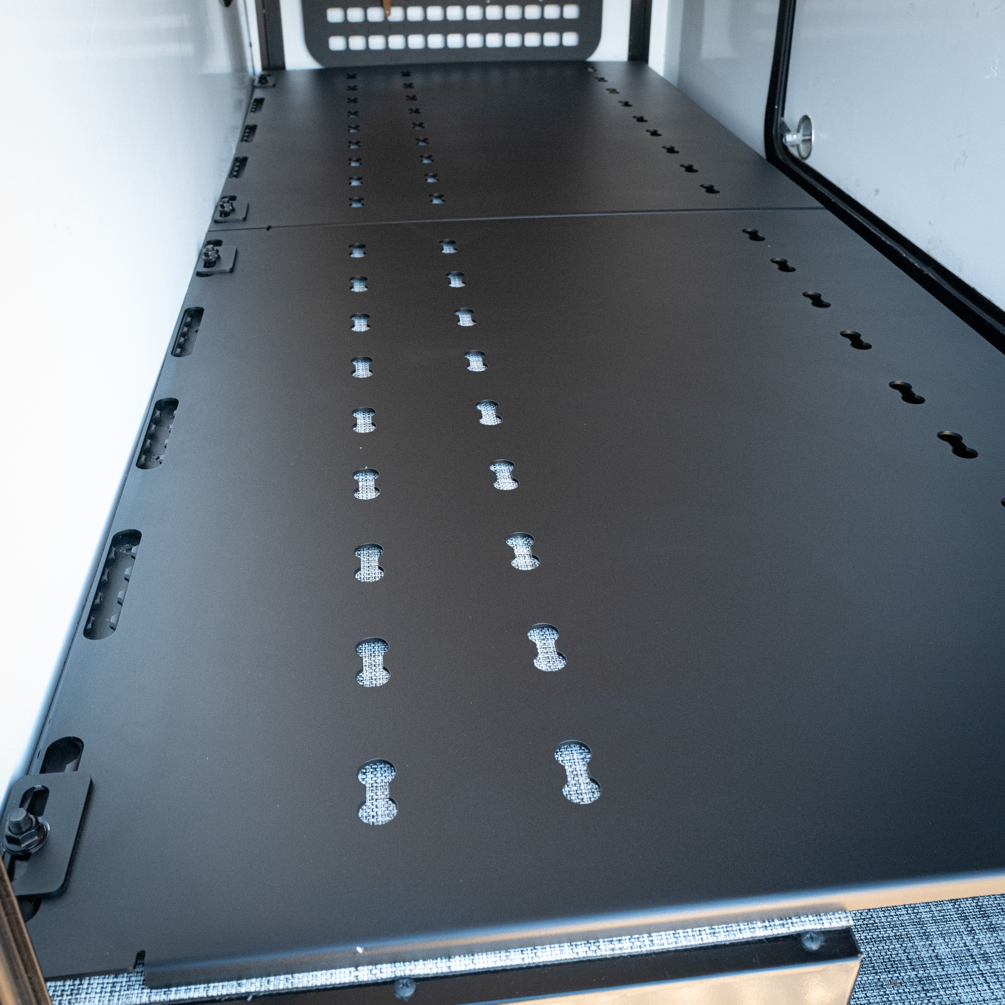 black aluminum ekko garage platform with l track slots to mount gear in winnebago ekko sitting over garage base