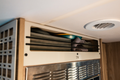 Ekko kitchen cabinet face plate beige with storage compartment and bungee in mercedes sprinter winnebago ekko van interior above microwave