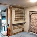 Ekko MOLLE Shelf System beige mounted on van interior wall near bed with ekko microwave showing in background